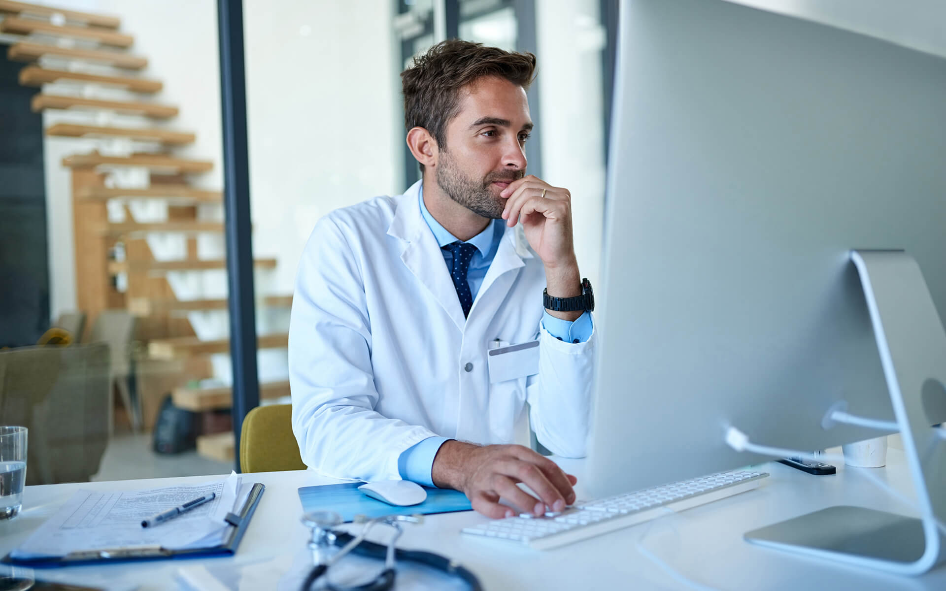 Doctor looking at computer.