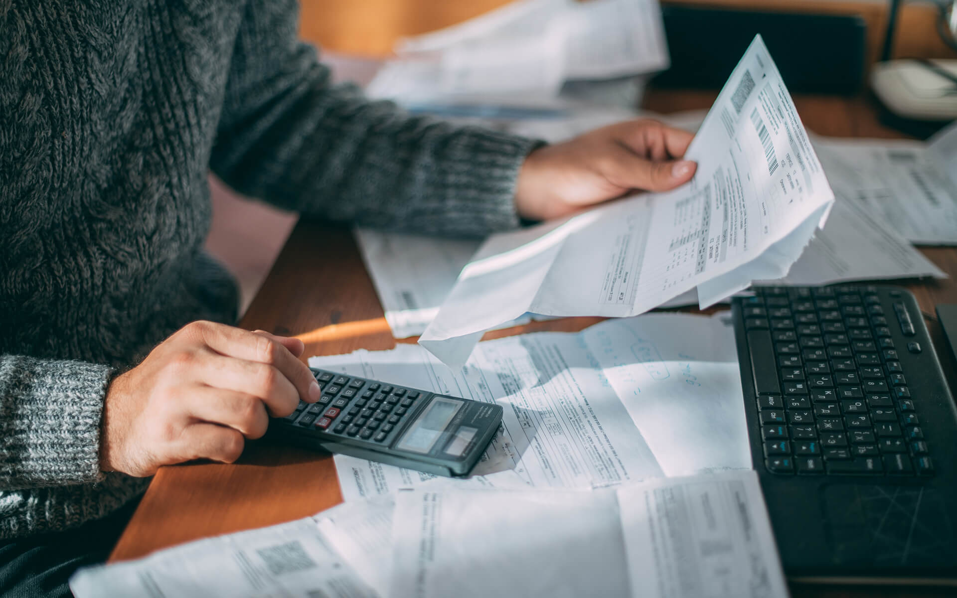 Man calculating overwhelming bills.