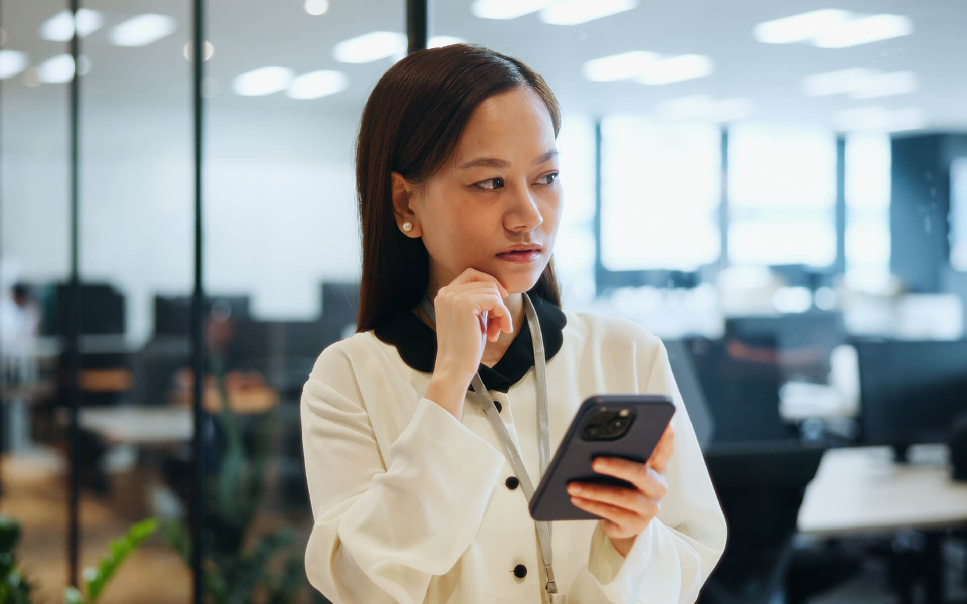 Woman looking suspicious with her phone.