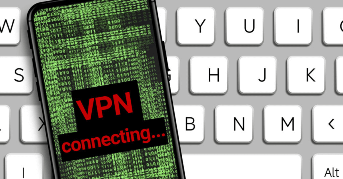 vpn connecting word on the screen of a cell phone laying on a keyboard.