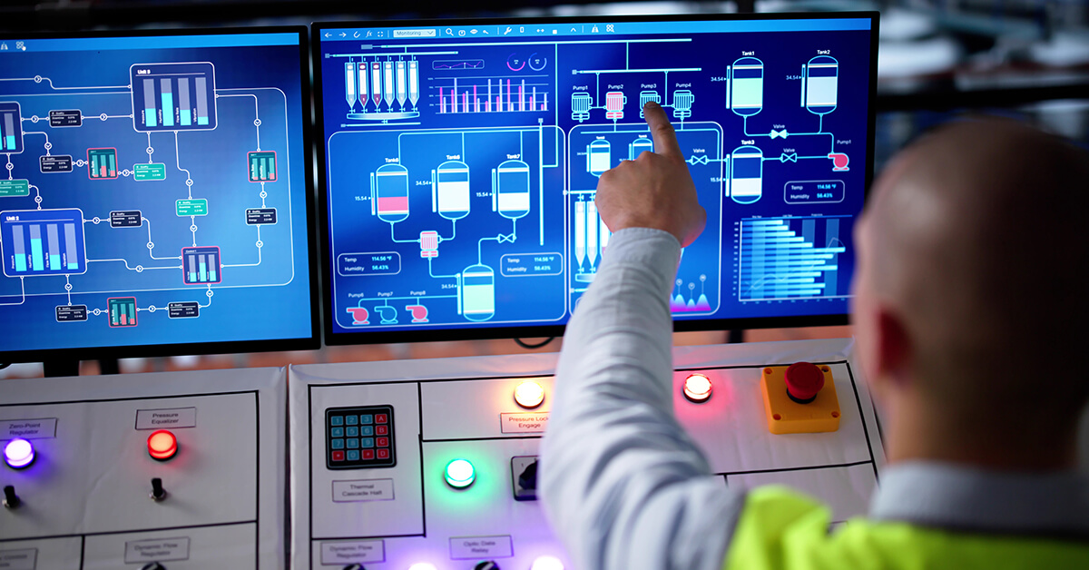 Operator monitoring SCADA systems and connected industrial processes from a control station.