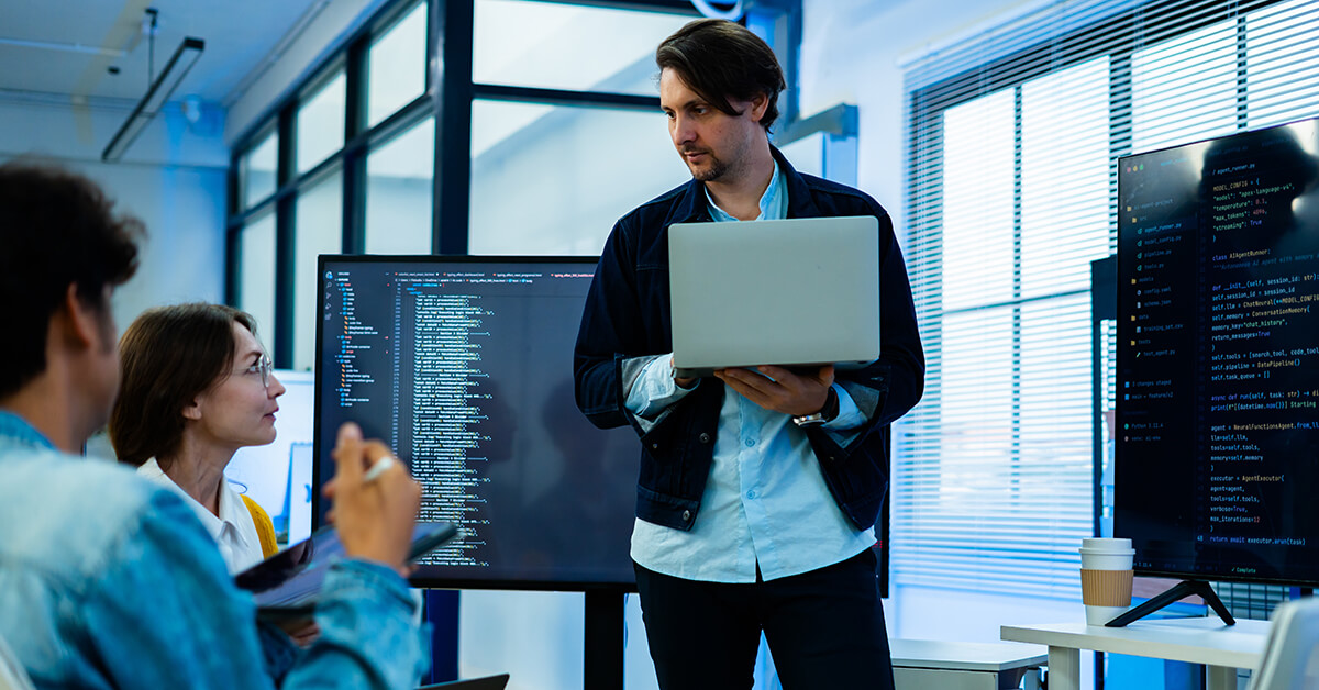 Cybersecurity specialist working with an internal IT team to investigate technical systems.