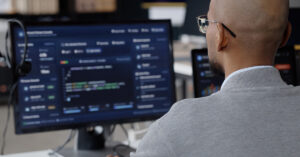 IT professional monitoring systems and network activity from a workstation.